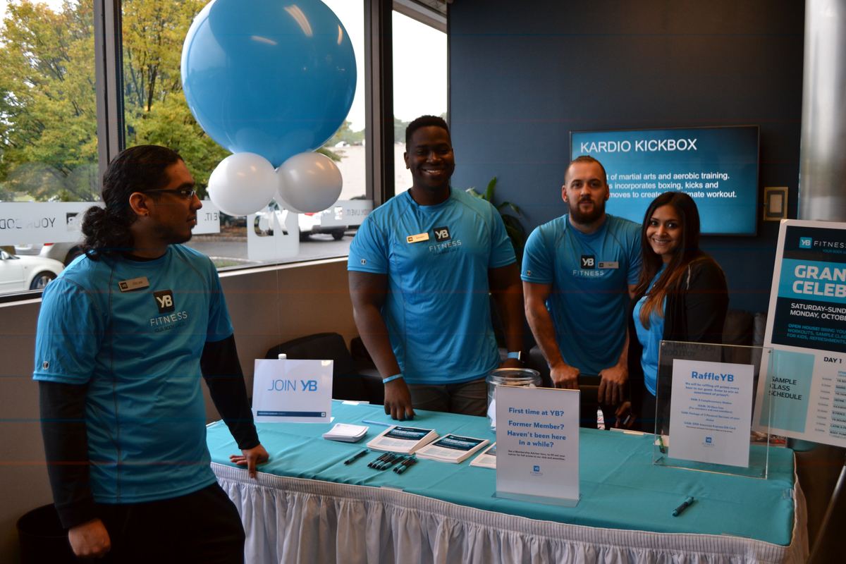 The YB Fitness team at a membership desk